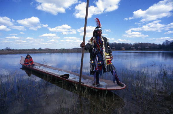 seminole indians in a canoe in the florida everglades